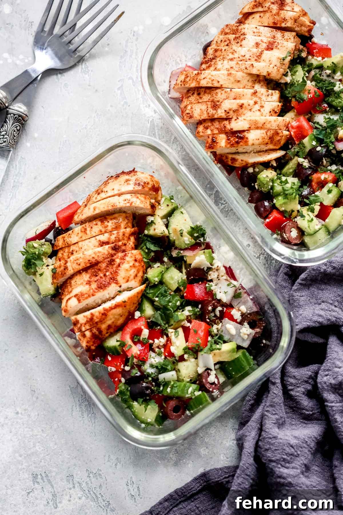 Freshly prepared Greek Chicken Salad with grilled chicken, feta, and crisp vegetables in meal prep containers