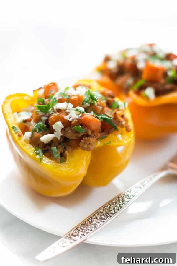 Close up of ground turkey sweet potato stuffed inside of a yellow bell pepper, showing the rich filling.