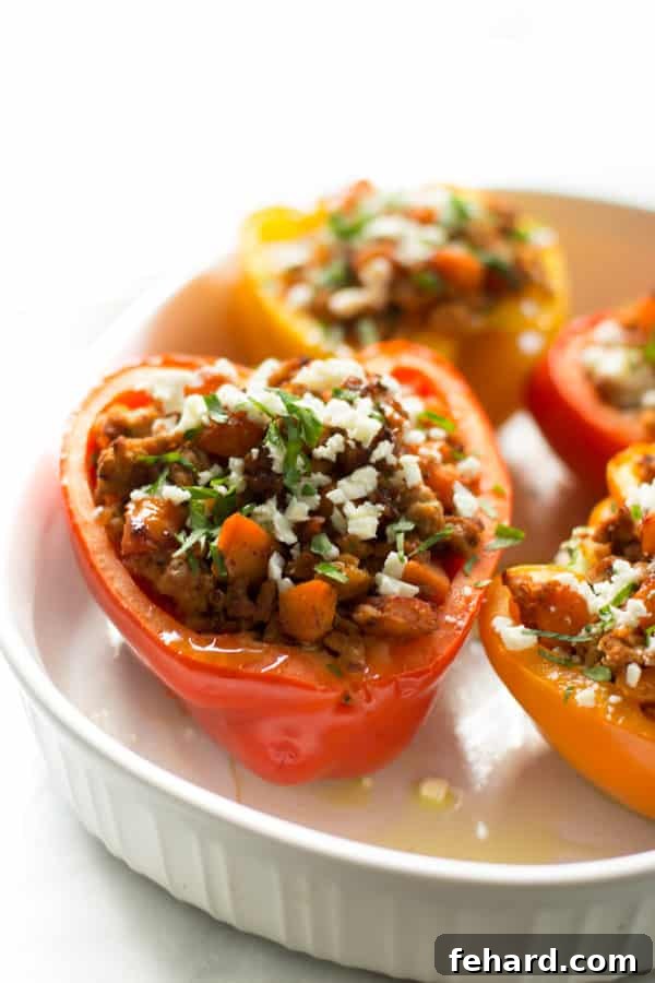 Close up of ground turkey sweet potato stuffed in a red bell pepper, ready for baking.