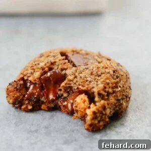 A photo of Chocolate Chunk Hazelnut Cookies with a bite taken out of it.