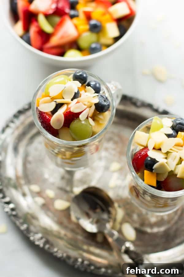 Quick Easy Fruit Salad, a vibrant mix of fresh fruits served in a clear bowl.