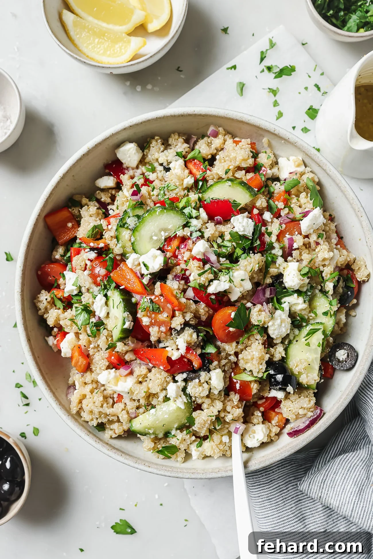 Vibrant Greek Quinoa Salad 2 A close-up view of a vibrant Greek quinoa salad, showcasing its fresh ingredients and fluffy quinoa in a clean white bowl.