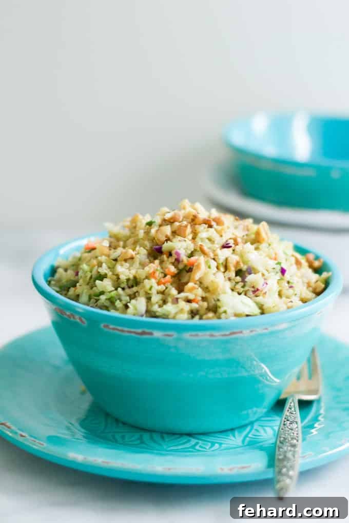 A vibrant teal bowl brimming with a colorful quinoa and cabbage salad, showcasing its fresh ingredients and appealing texture.