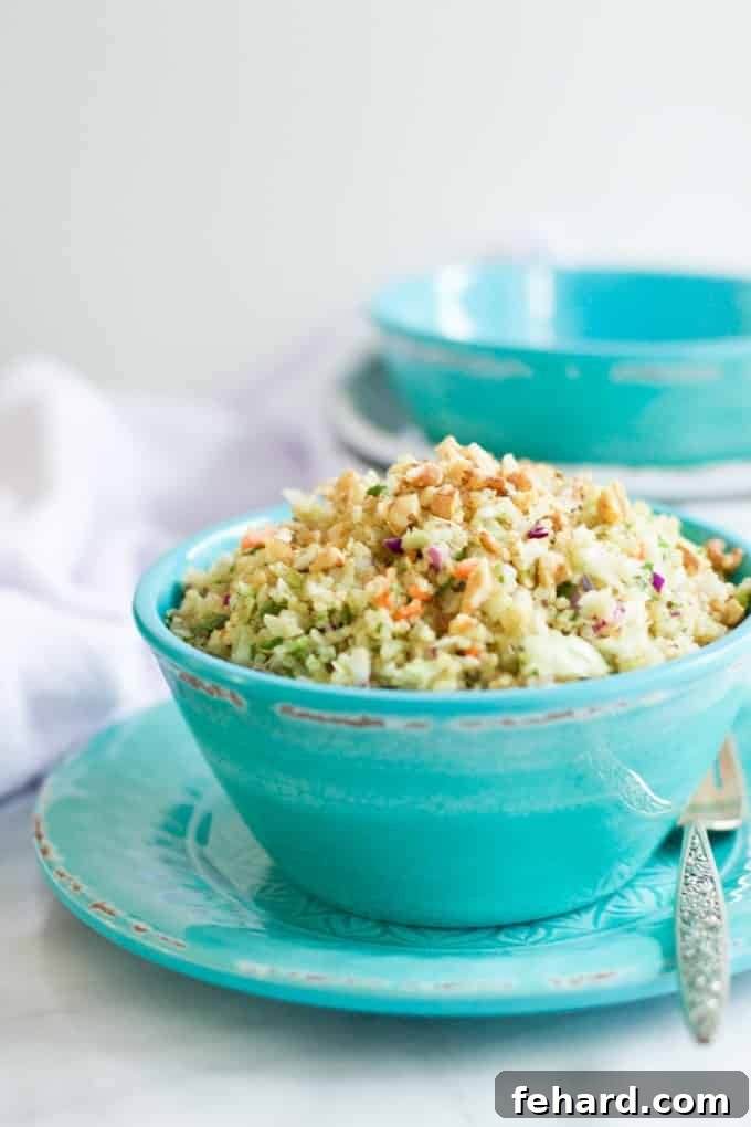 A straight-on view of a teal bowl filled with a refreshing quinoa and cabbage salad, ready to be enjoyed.