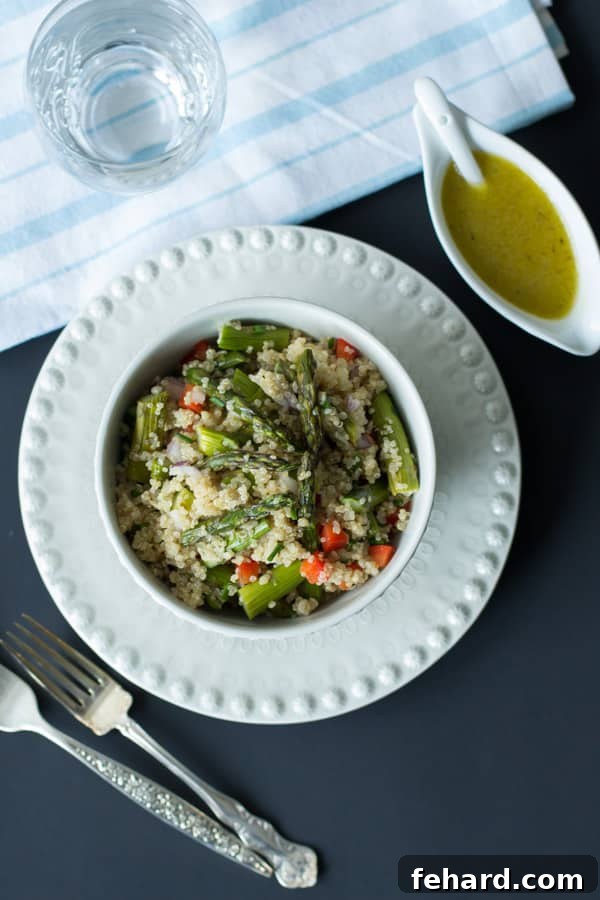 A refreshing quinoa salad featuring perfectly roasted asparagus spears.