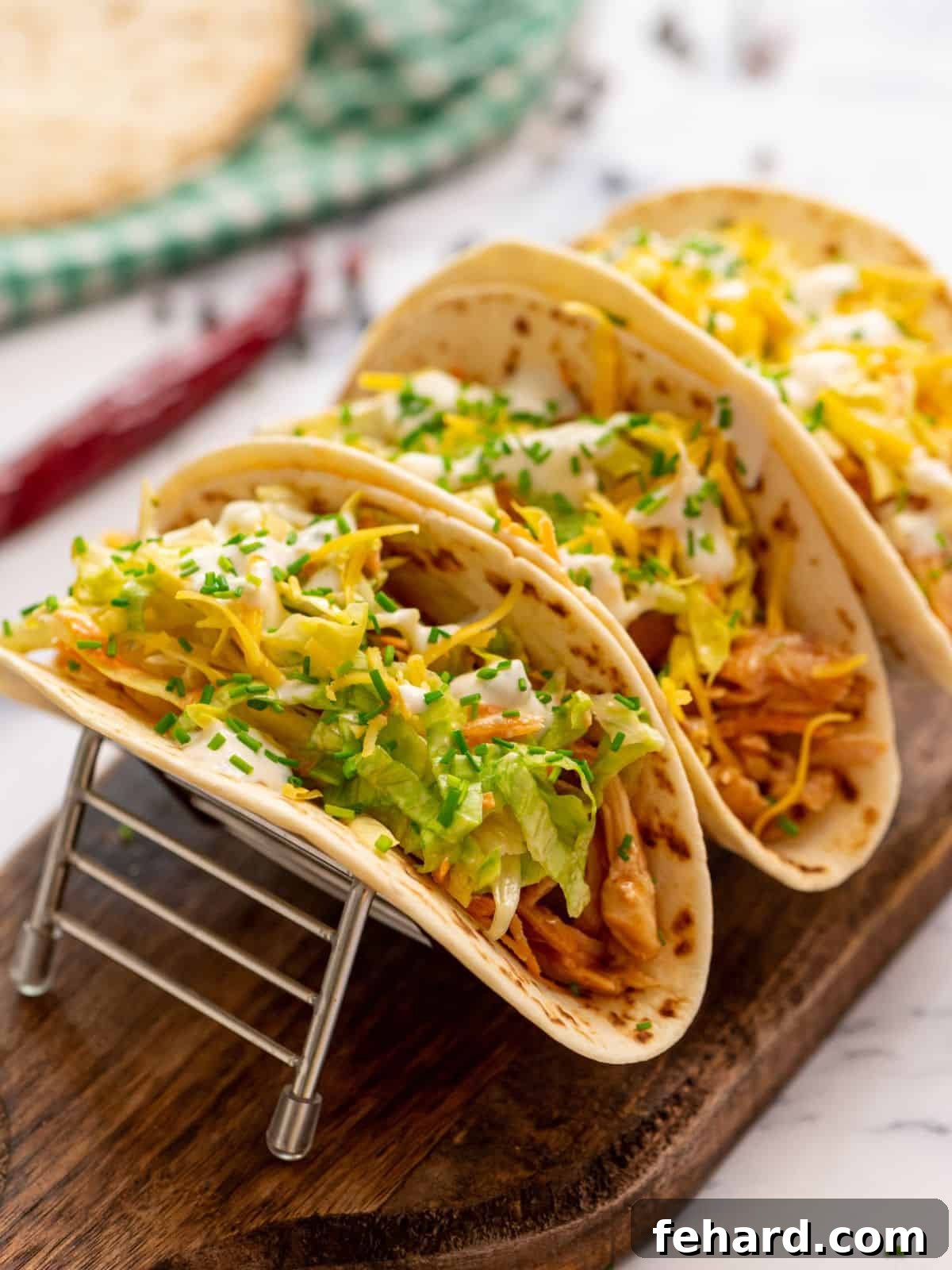 Buffalo Chicken Tacos Shredded buffalo chicken topped with ranch lettuce slaw in tortilla shells.
