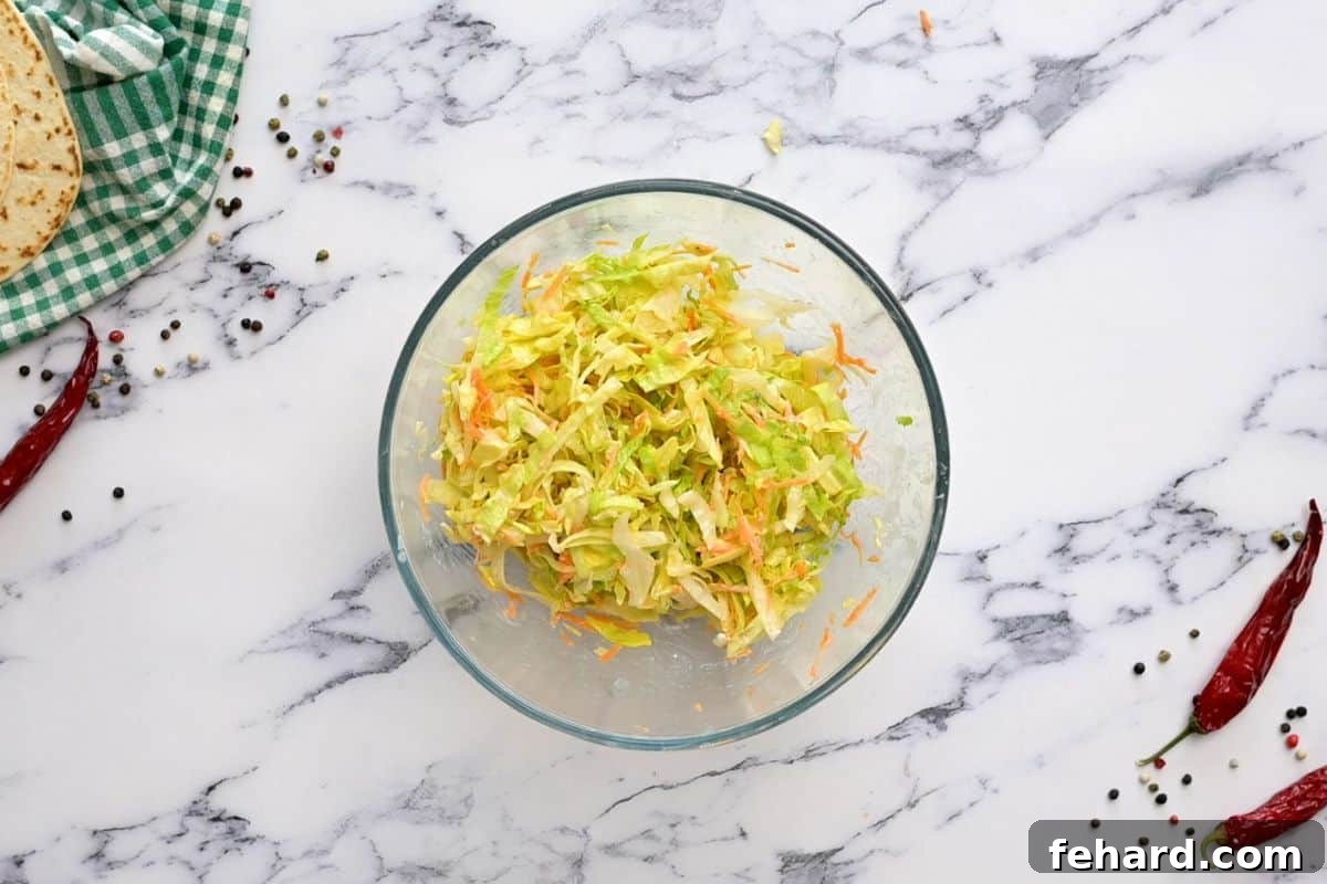 Buffalo Ranch Slaw Preparation Lettuce, carrots and ranch dressing tossed together in medium mixing bowl.