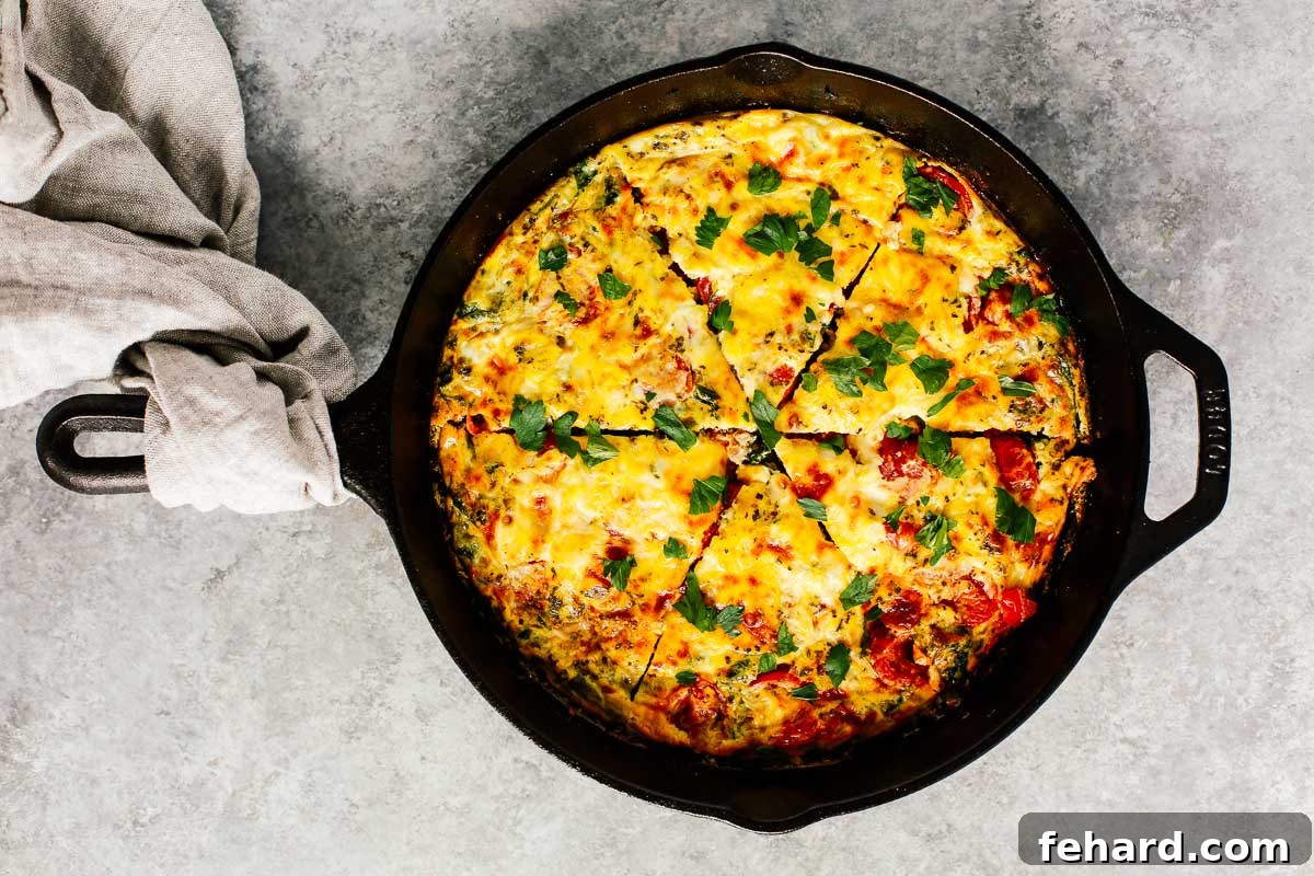 A perfectly baked vegetable frittata cooling in a cast-iron skillet, ready to be sliced and served.