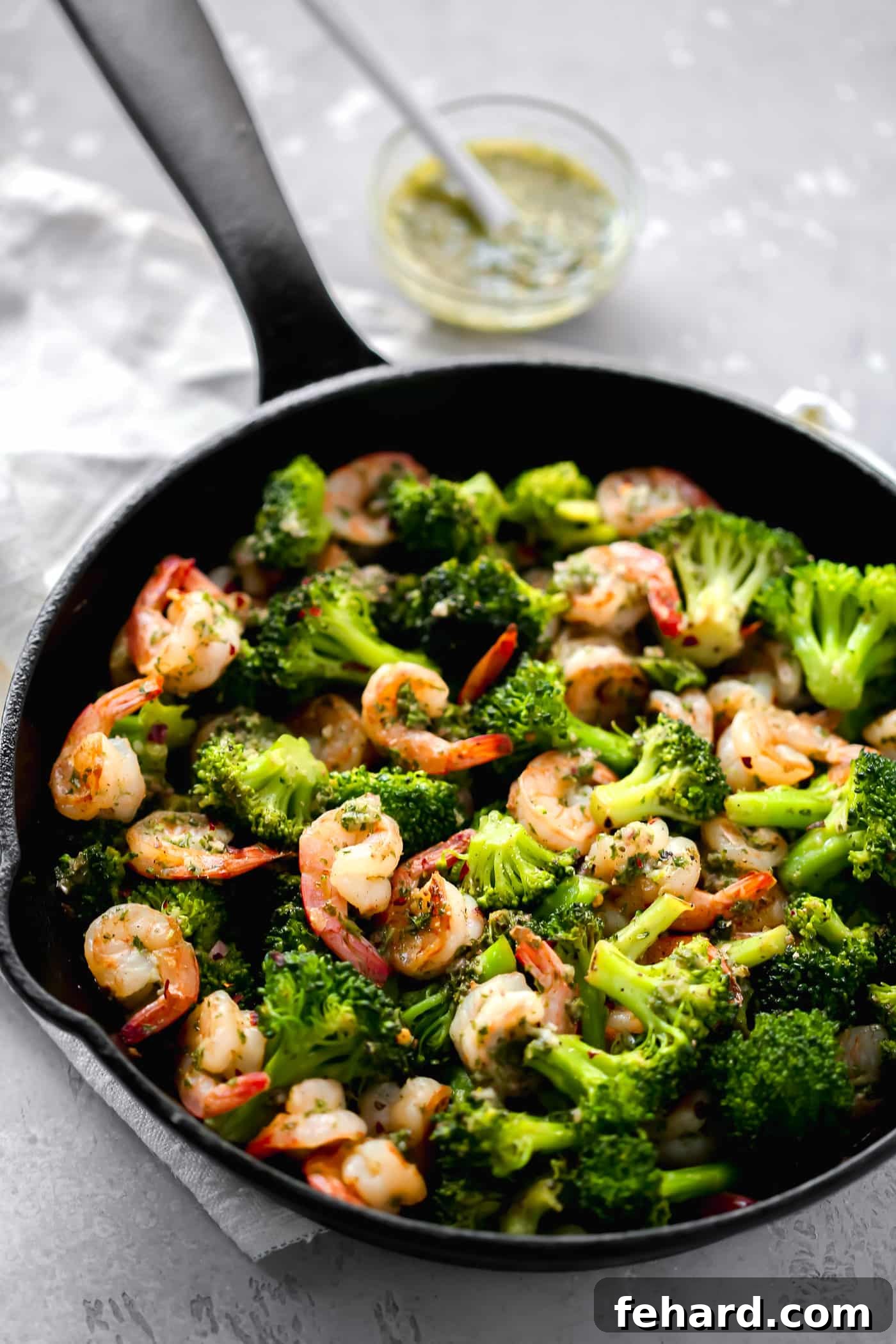 Effortless Keto Dinners 5 close-up of shrimp and broccoli in a skillet