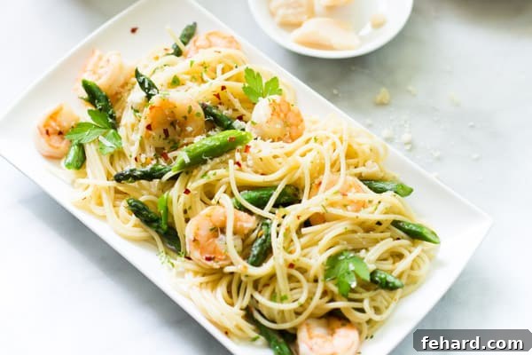 Overhead photo of a platter of garlic shrimp spaghetti, showcasing the full dish.