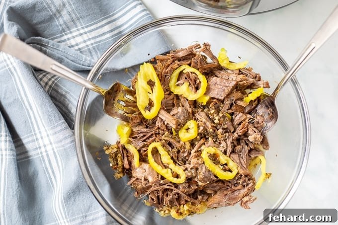 Shredded Italian Beef Bowl of perfectly shredded Italian Beef, generously topped with vibrant pepperoncini peppers.