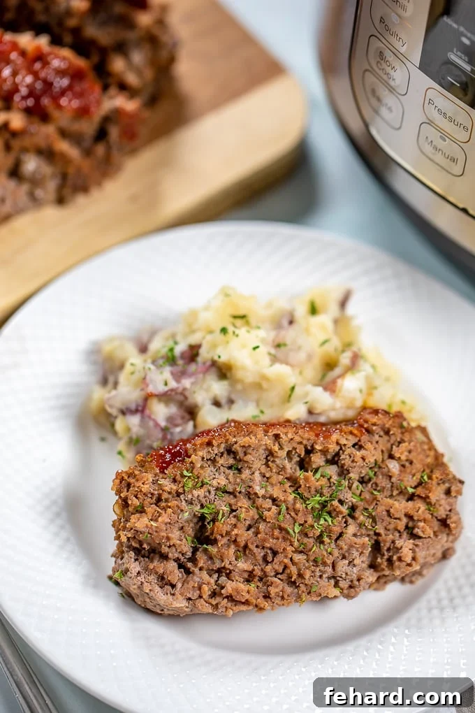 Slice of Meatloaf with mashed potatoes next to Instant pot.