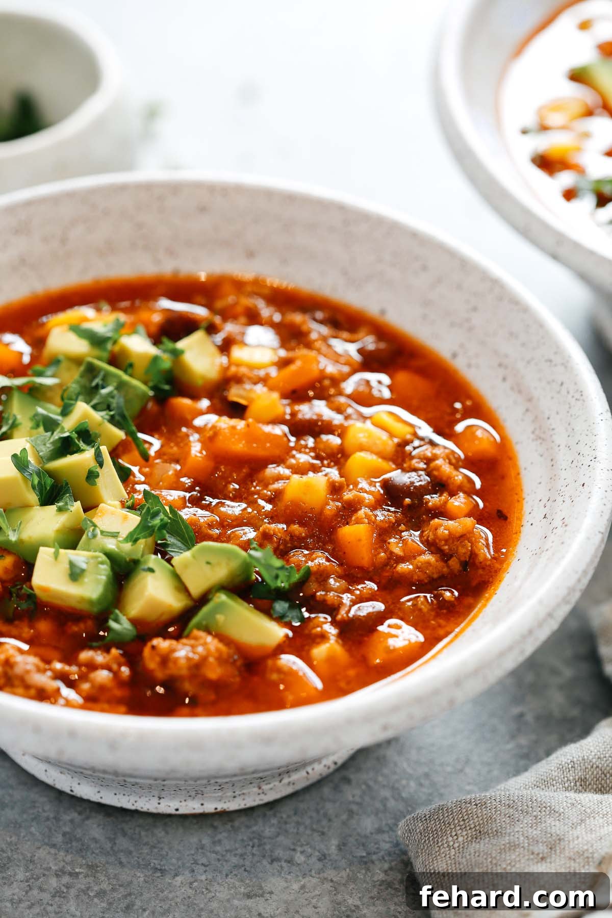Easy Instant Pot Taco Soup 4 close-up of instant pot taco soup in a white bowl.