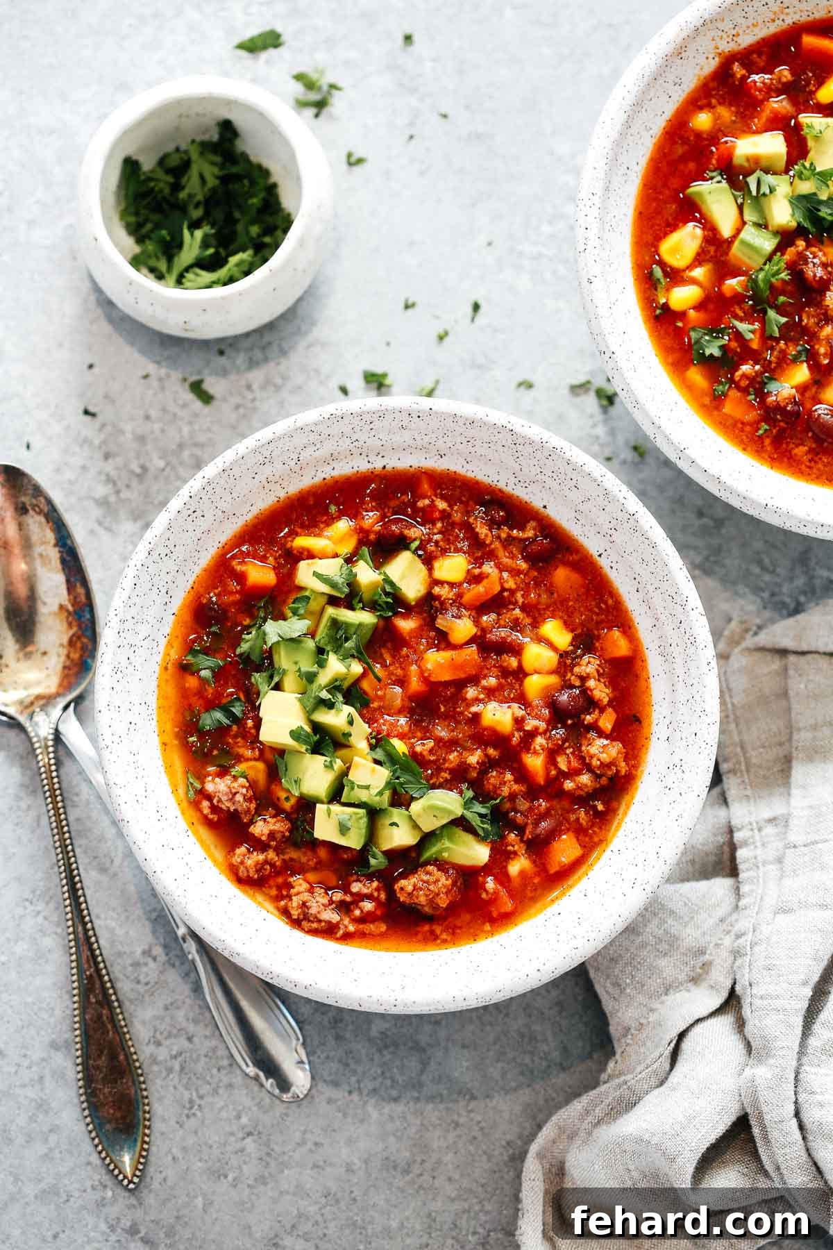 Easy Instant Pot Taco Soup 5 Instant Pot taco soup in a white bowl with avocado on top.