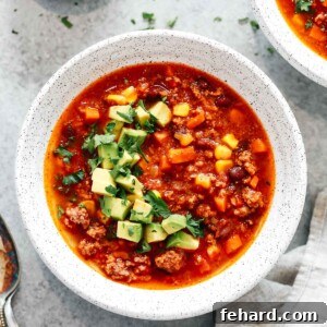 Easy Instant Pot Taco Soup 6 overhead view of a bowl of Mexican taco soup with chopped avocado garnish