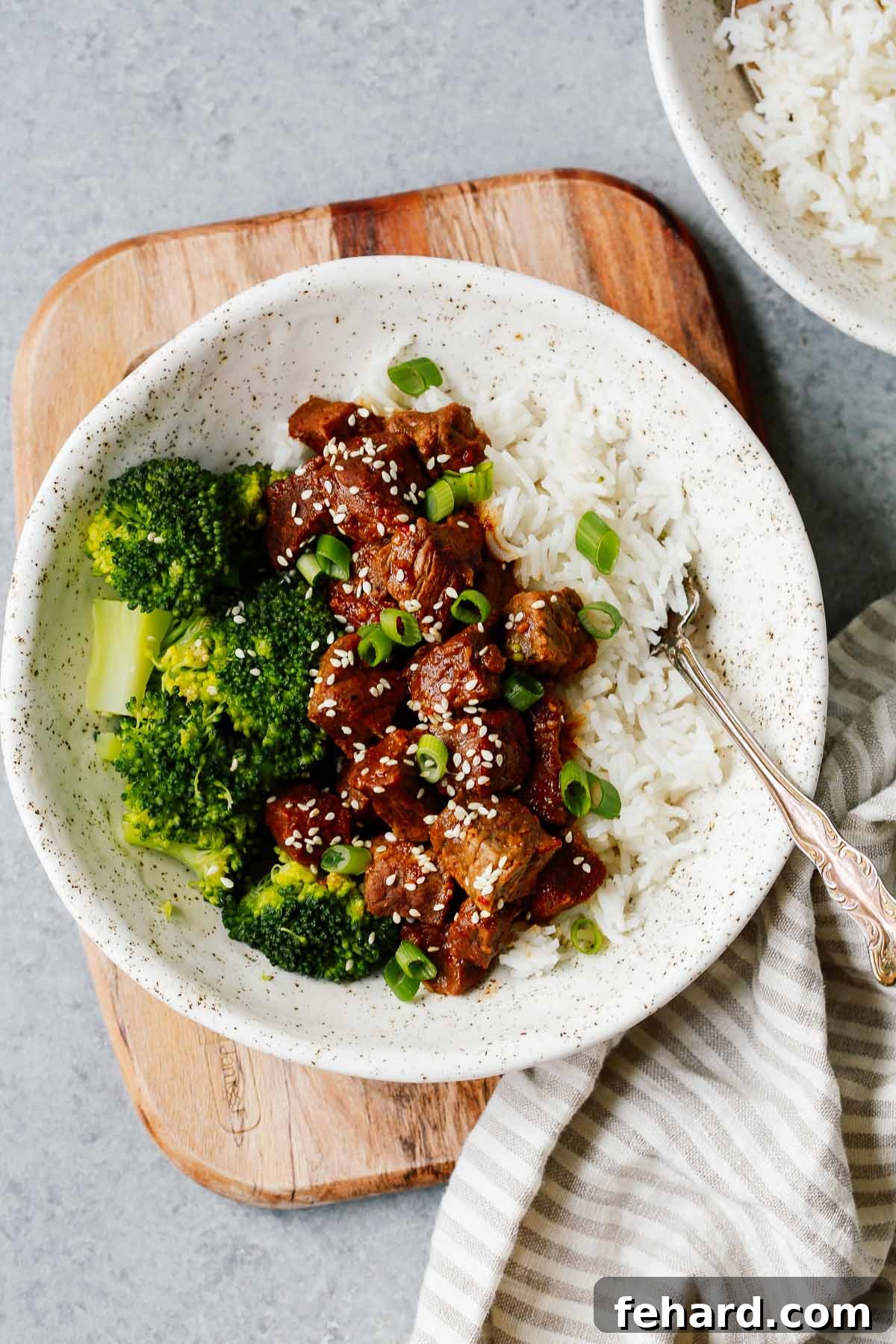 Fast and Flavorful Instant Pot Korean Beef 2 white place with Instant Pot Korean beef served over white rice with broccoli