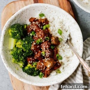 white place with Instant Pot Korean beef served over white rice with broccoli
