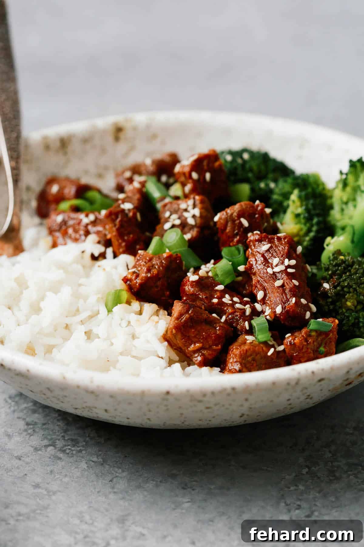 Fast and Flavorful Instant Pot Korean Beef 5 Instant Pot Korean beef on white plate with sides of white rice and steamed broccoli