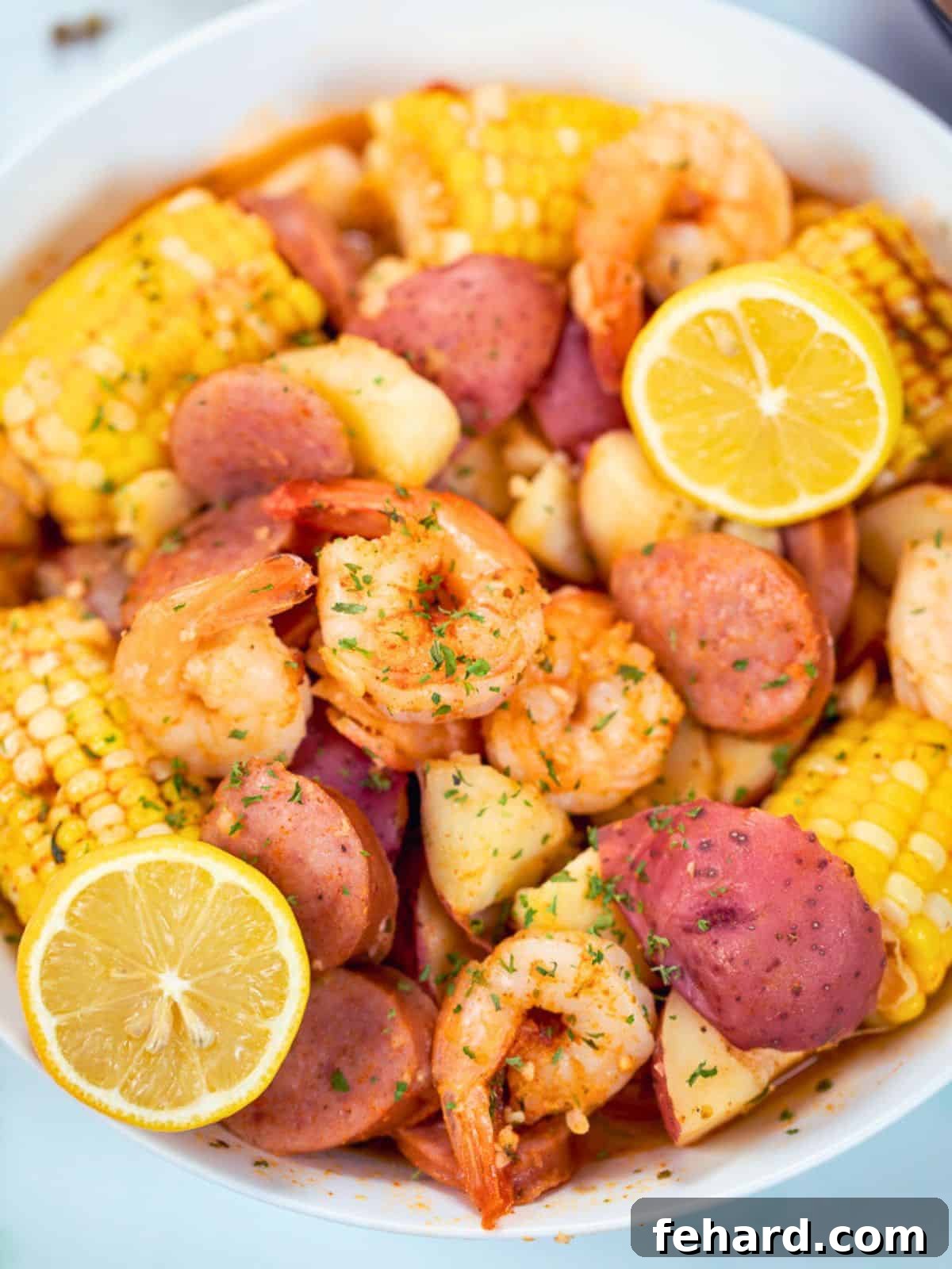 Instant Pot Shrimp Boil with fresh lemons in a white platter next to Instant Pot.