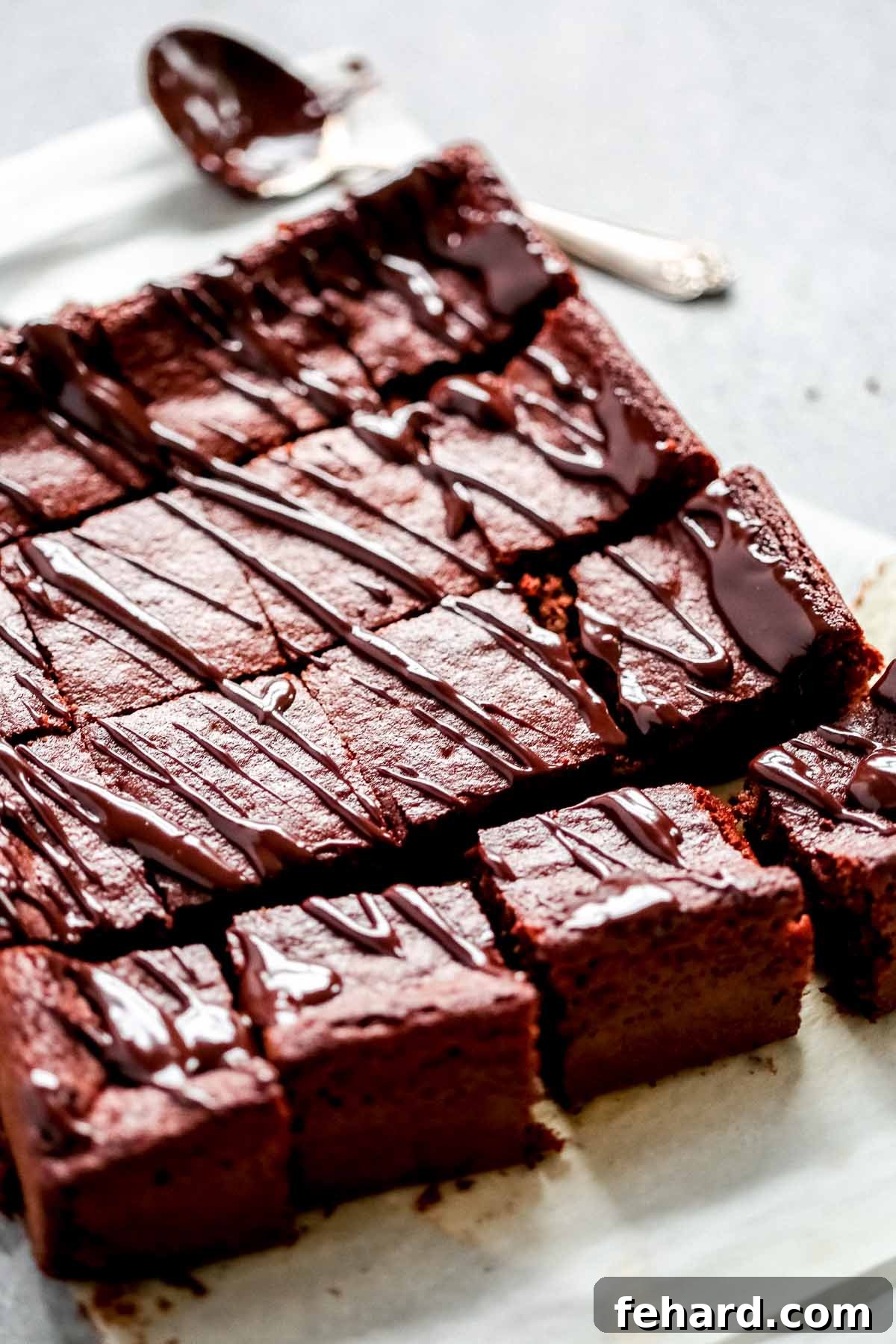 Irresistible Homemade Chocolate Bars 5 A close-up of low-carb brownies neatly cut into squares on a cooling rack.