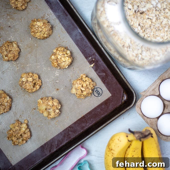 Unbaked Peanut Butter Dog Treats scooped and flattened on a baking sheet