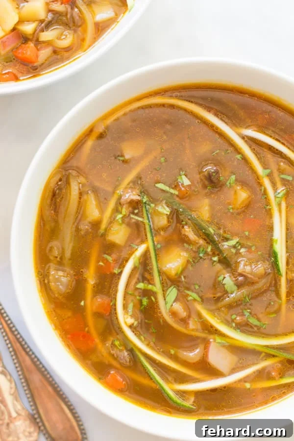 A tantalizing close-up shot of the finished zucchini noodle soup in a rustic bowl, garnished with fresh parsley, highlighting the vibrant colors of the ingredients and the appealing texture of the zoodles.