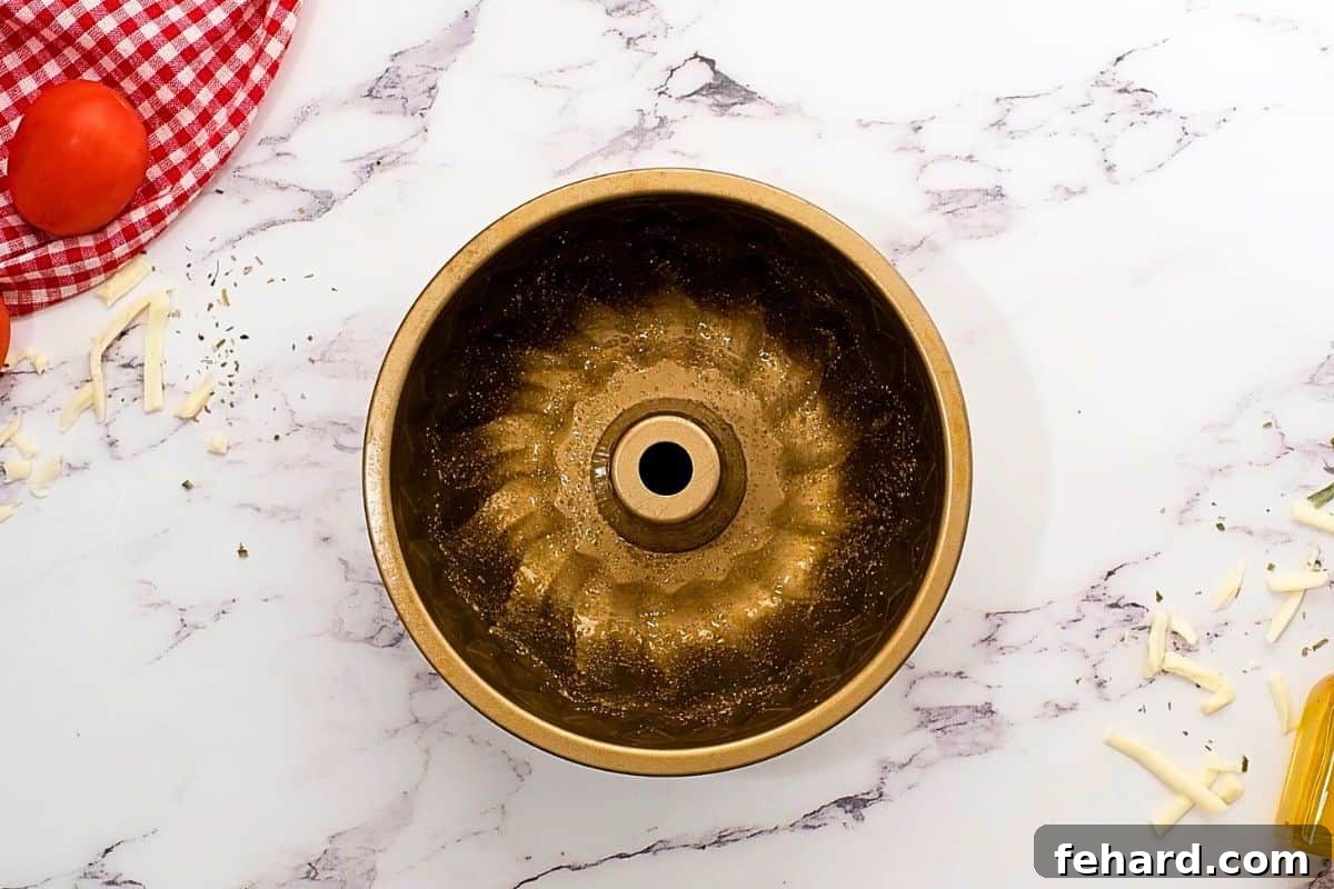 A bundt pan lightly greased with fragrant garlic oil, ready for the pizza dough.