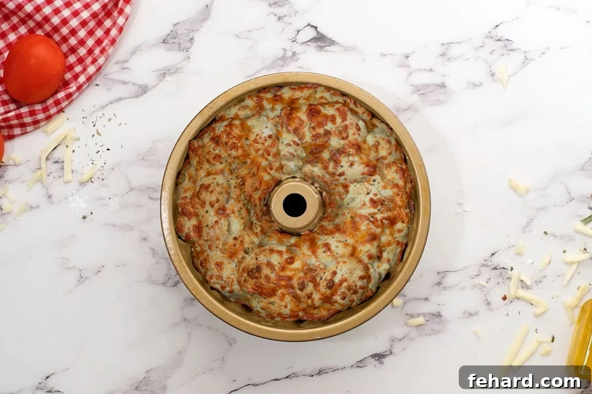 Freshly baked cheesy Pizza Bread in a Bundt Pan, golden and ready to serve.