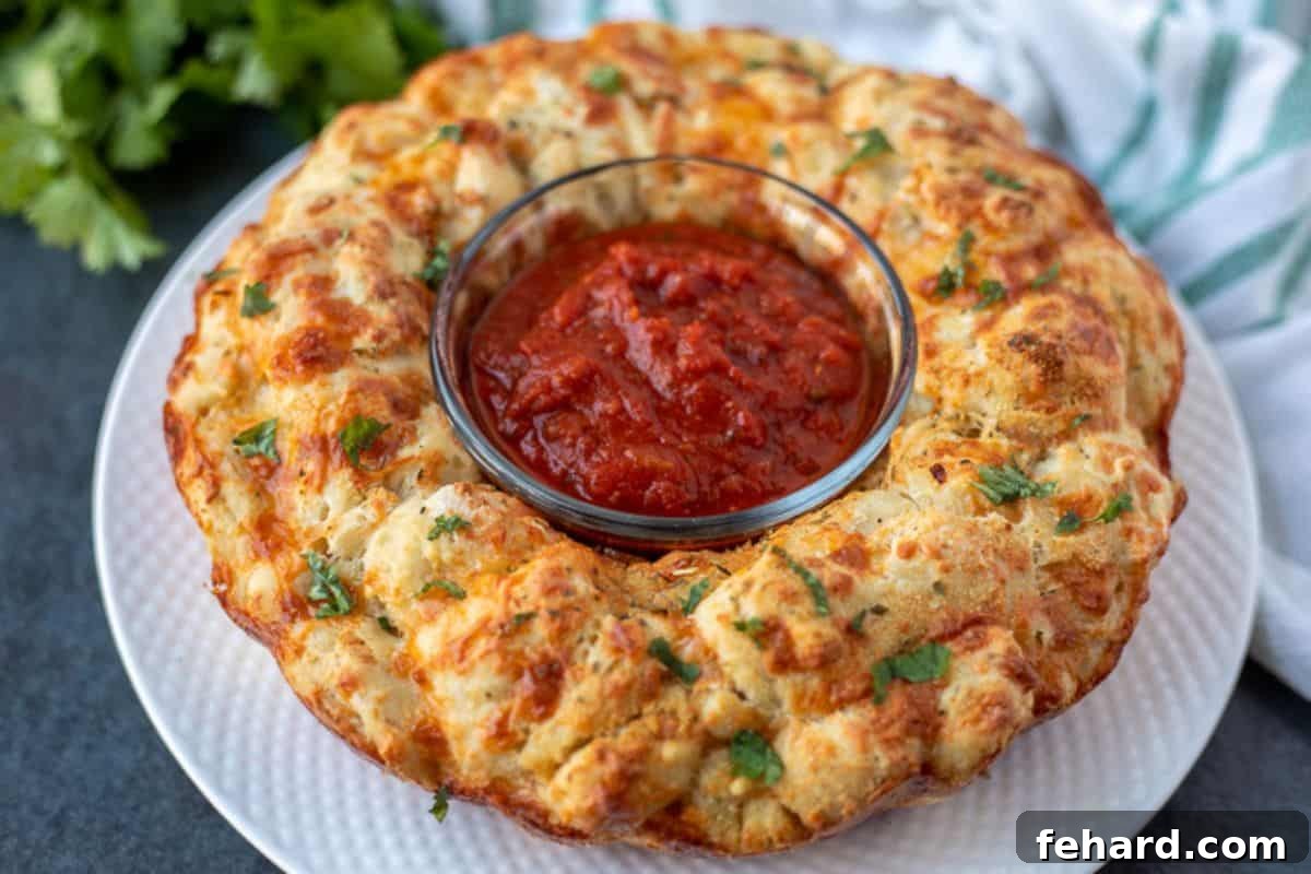 Pizza bread inverted on a white plate, garnished with parsley and served with a bowl of pizza sauce in the middle.