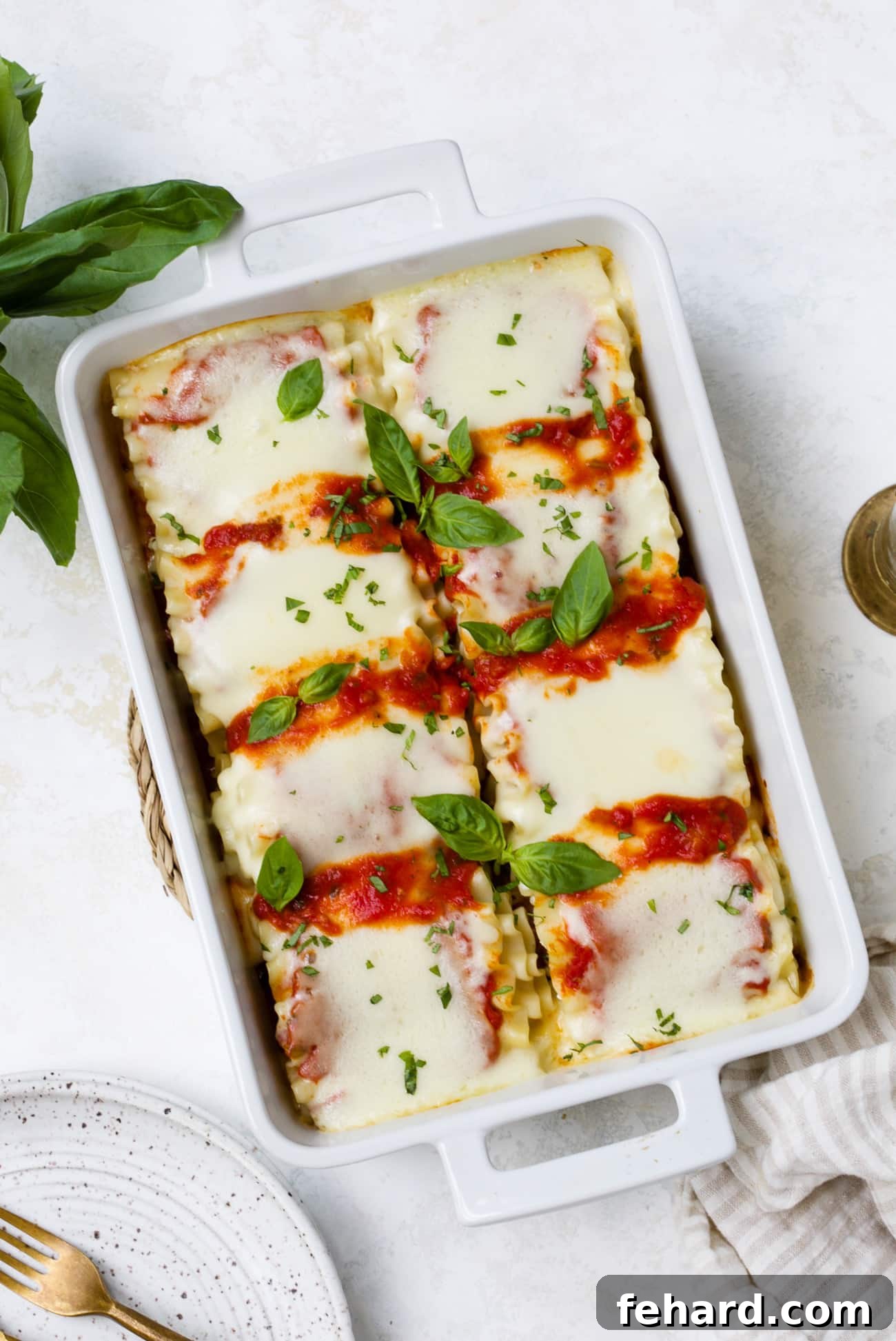 A large casserole dish filled with beautifully baked lasagna roll-ups, fresh from the oven and ready to be enjoyed.