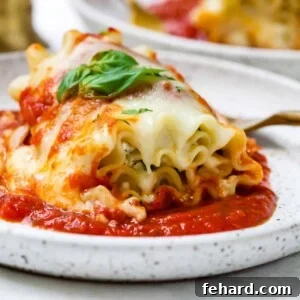 Closeup of lasagna roll ups on a white plate