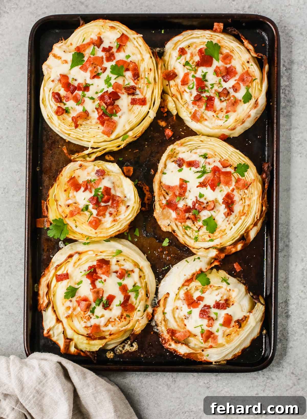 cabbage steaks on a baking sheet