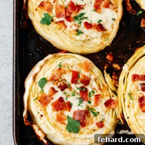 overhead view of roasted cabbage steaks with mozzarella and bacon on a baking sheet