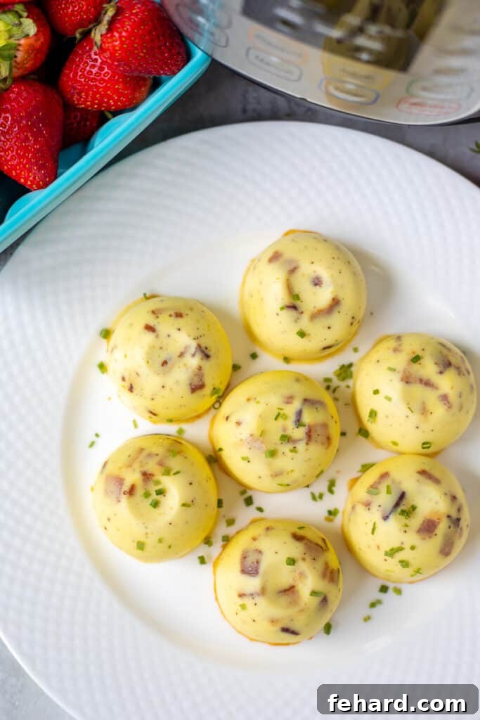 Delicious Bacon and Swiss Instant Pot Egg Bites on a white plate, ready to serve, next to an Instant Pot.