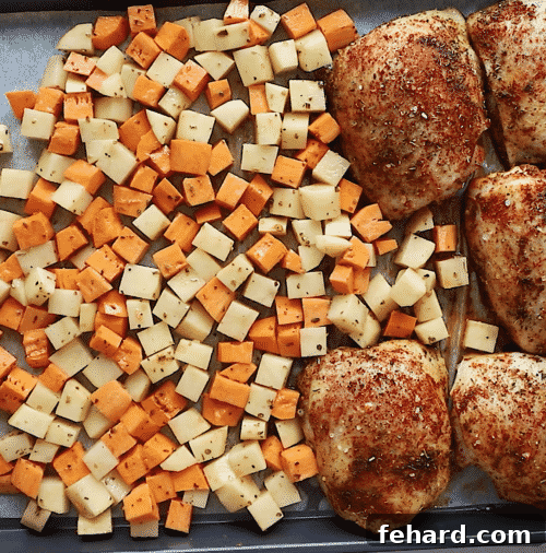 Golden Roasted Chicken and Garden Vegetables 9 overhead view of diced potatoes and chicken things on a baking sheet