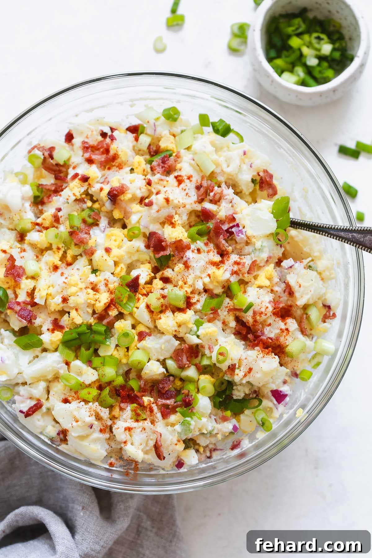 bowl of healthy potato salad garnished with paprika and fresh parsley