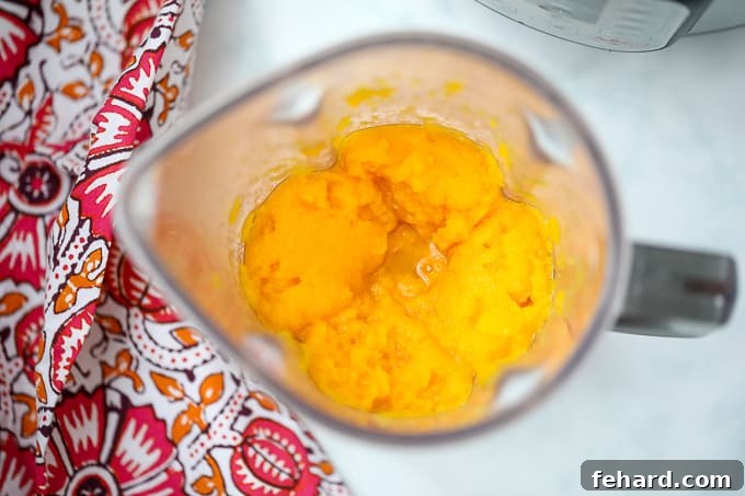 Butternut squash puree inside a blender, ready for blending to a smooth consistency.