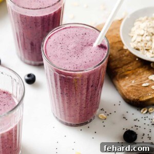 Creamy Blueberry Banana Smoothie in a glass with fresh blueberries