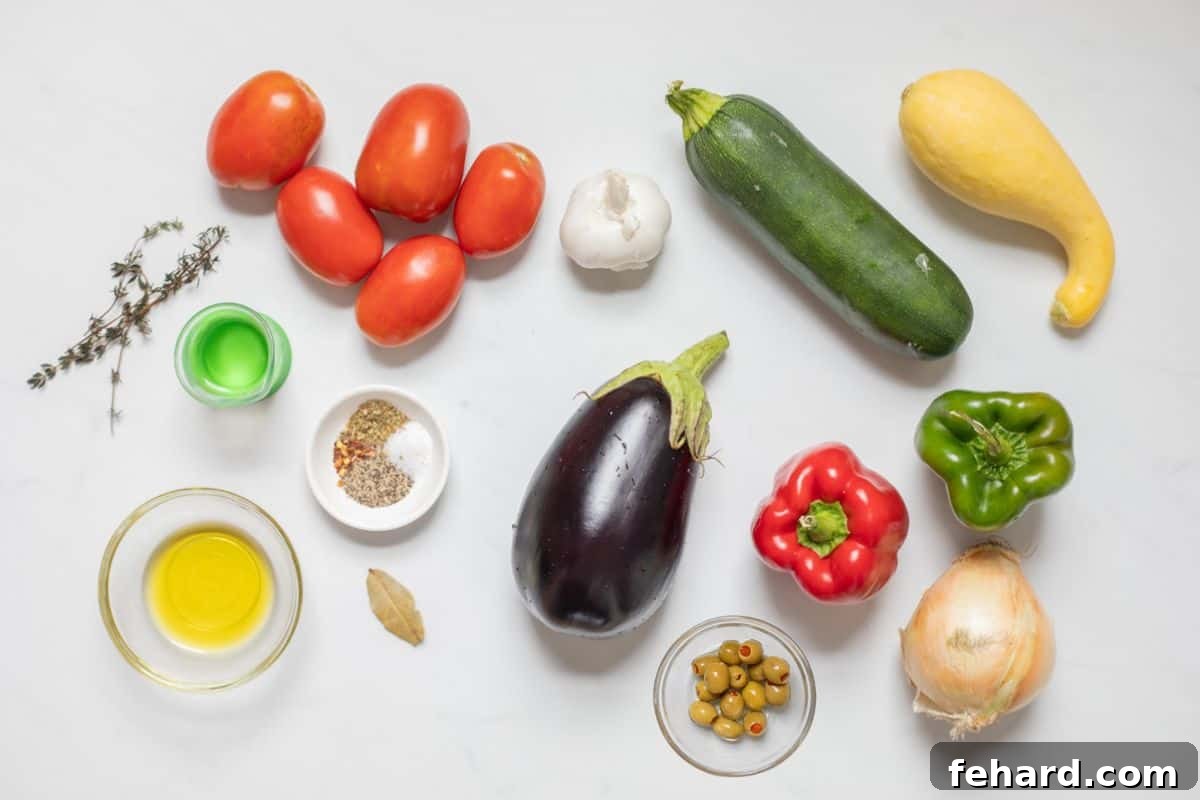Ingredients for classic Ratatouille laid out on a kitchen counter, including eggplant, peppers, tomatoes, zucchini, onions, garlic, olive oil, and herbs.