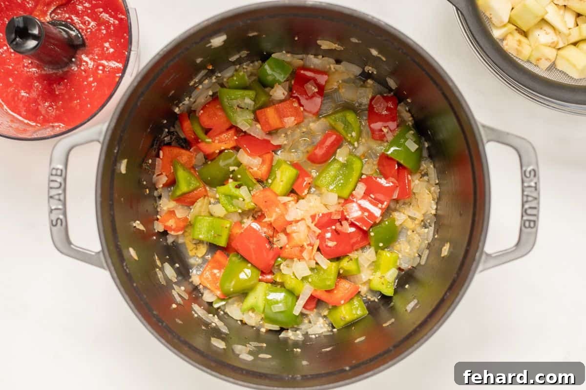 Sauteed vegetables in a large stock pan, after being softened and dry white wine added to deglaze the pan.