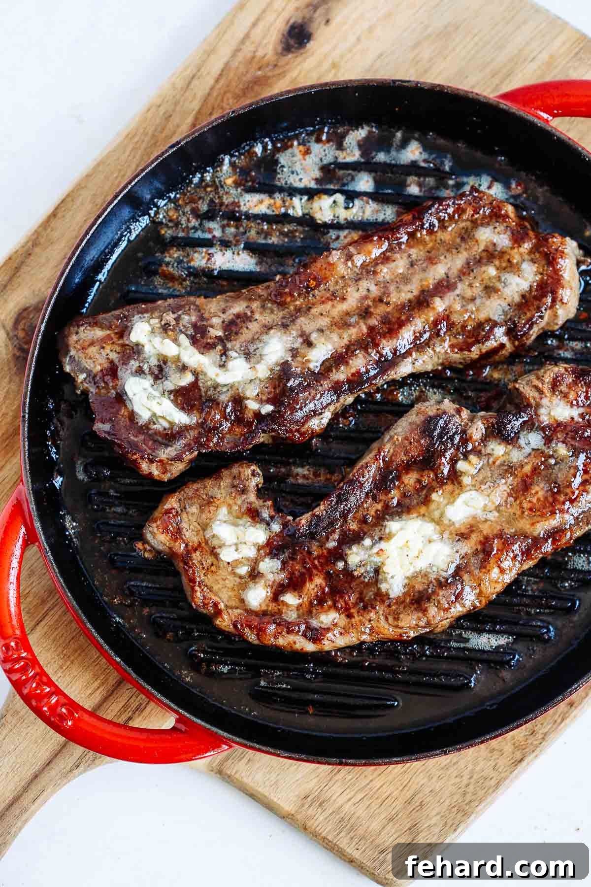 overhead view of garlic butter steak in a cast iron skillet