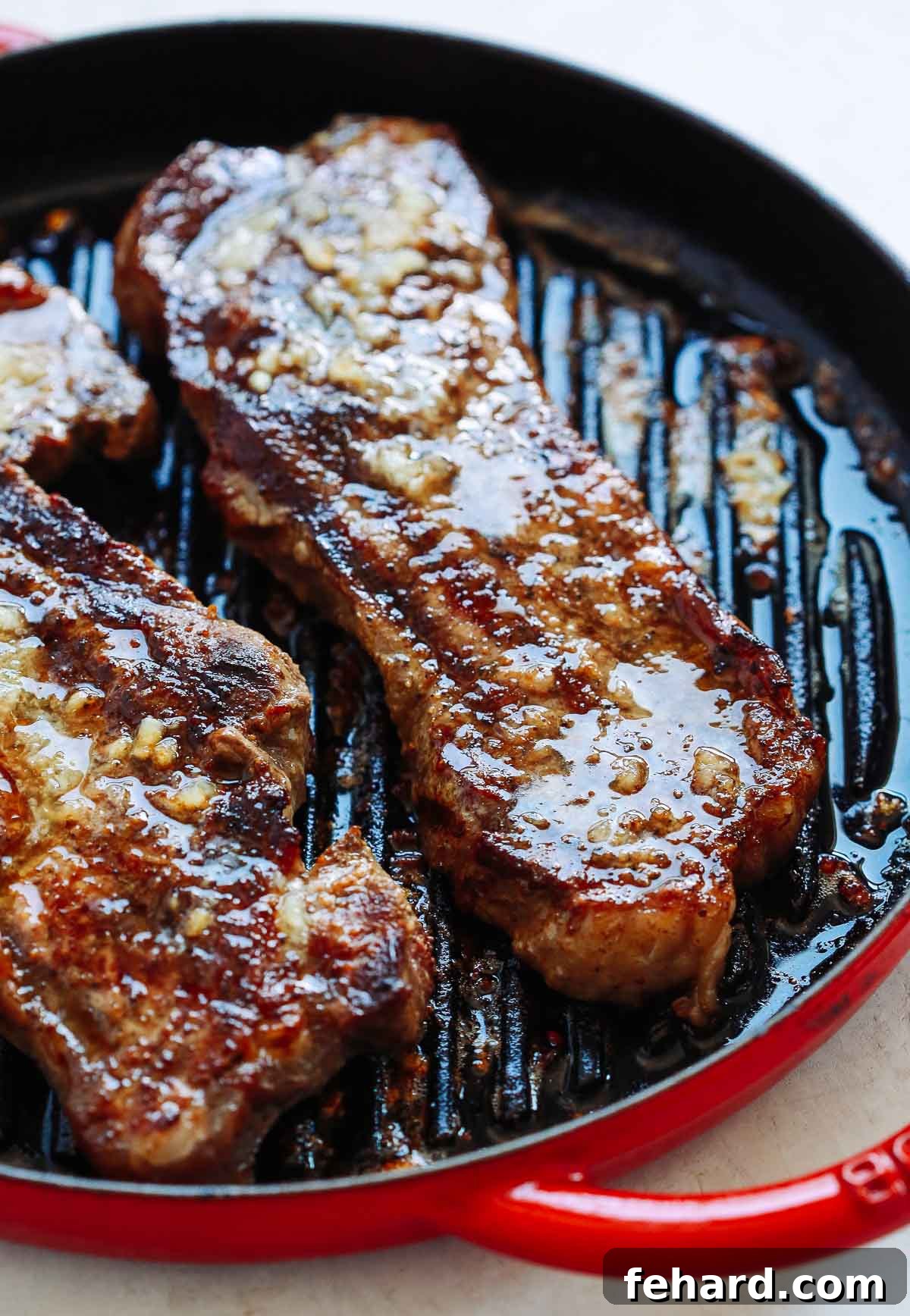 overhead photo of a garlic butter steak in a skillet 