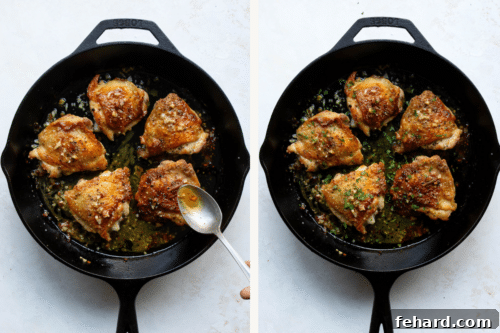Baked chicken thighs in a skillet, garnished with parsley and butter sauce.