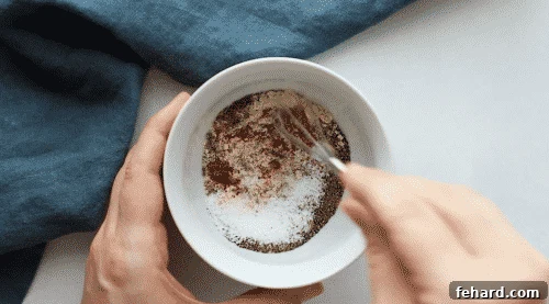 a white small bowl with spices inside