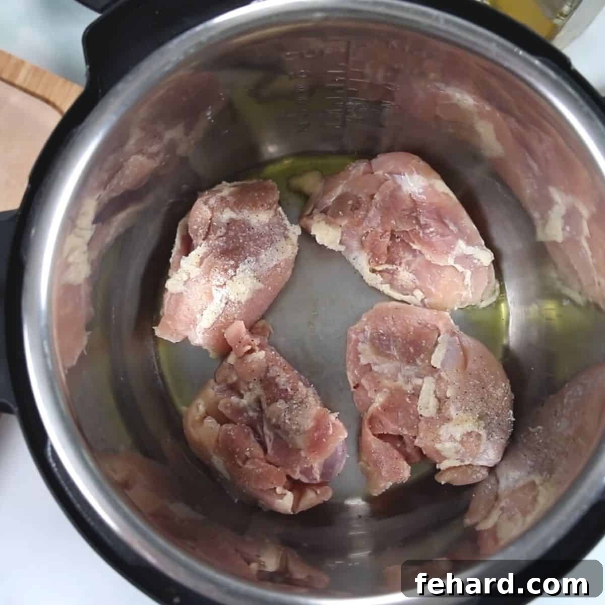 Chicken Thighs in inner pot of instant pot.