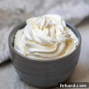 Piped whipped cream in a gray bowl, garnished slightly.