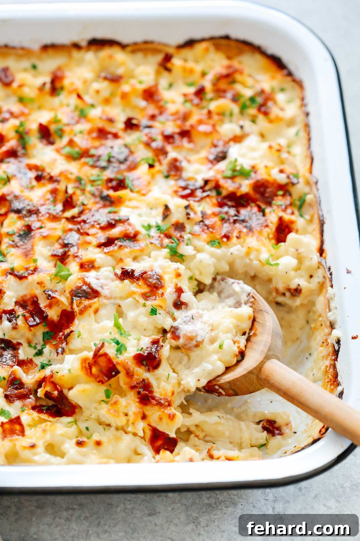 Golden Cauliflower Gratin 3 Close-up of a golden-brown cheesy cauliflower casserole in a baking dish, with crispy, melted cheese on top.