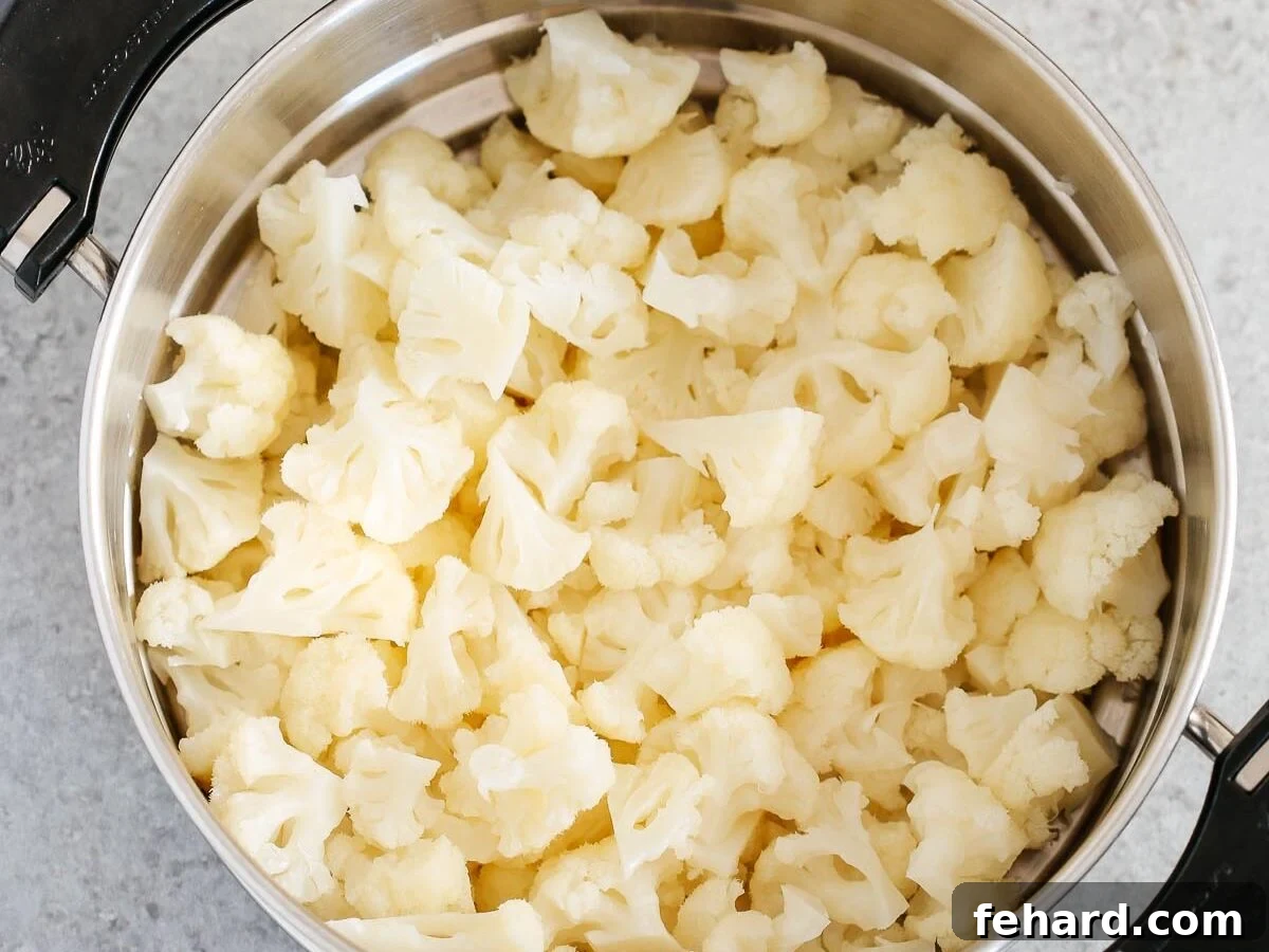 Golden Cauliflower Gratin 4 Steamed cauliflower florets in a metal steamer basket.