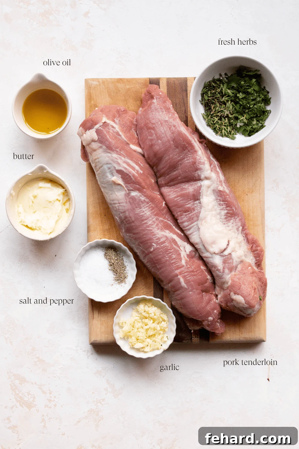 Mouthwatering Garlic Butter Pork Tenderloin 3 ingredients on a wooden board to make pork tenderloin recipe