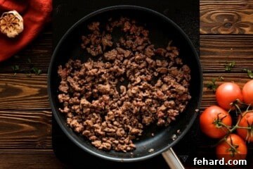 Ground beef sautéed in a skillet, seasoned and ready for the lasagna meat sauce.